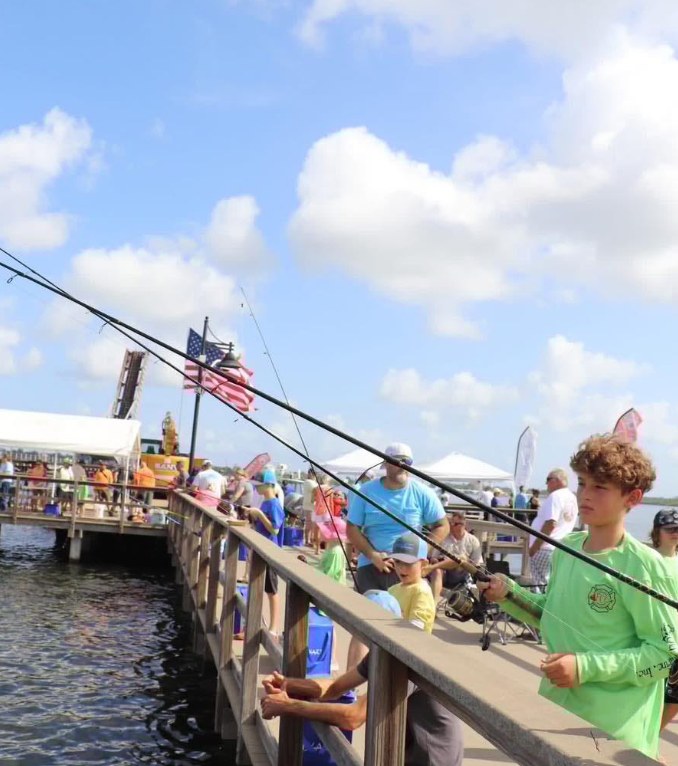 Children and families fishing from the pier at Bailey Riverbridge Gardens in Ormond Beach during a past Reel in the Fun kids fishing tournament.